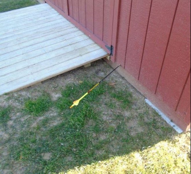 Environmental police released this photo of an arrow stuck in a shed at the Lawrence School in Falmouth, Massachusetts.