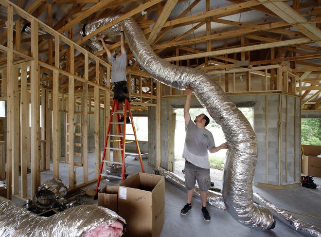 Shannon Smith, left, and Nicholas Payne install HVAC ducting in a home in Lakeland. A free program aims to relieve a shortage of HVAC installers in the Sarasota-Manatee area. [GATEHOUSE FLORIDA ARCHIVE / 2017]
