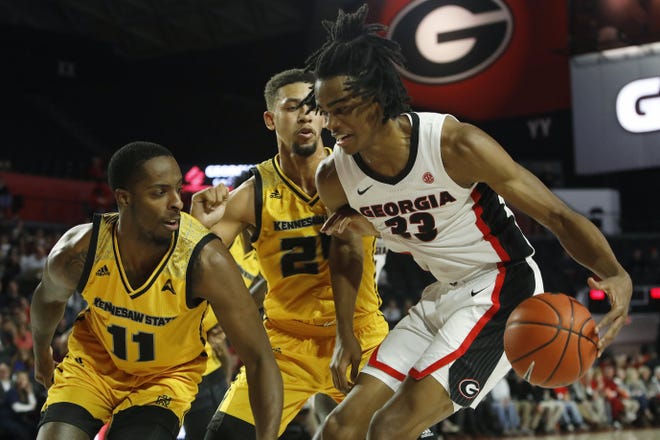 Georgia forward Nicolas Claxton (33) tries to get by Kennesaw State forward Bryson Lockley (24) and Kennesaw State guard Kyle Clarke (11) during an NCAA college basketball game between Georgia and Kennesaw State in Athens, Ga., Tuesday, Nov. 27, 2018. [Jenn Finch/Athens Banner-Herald via]