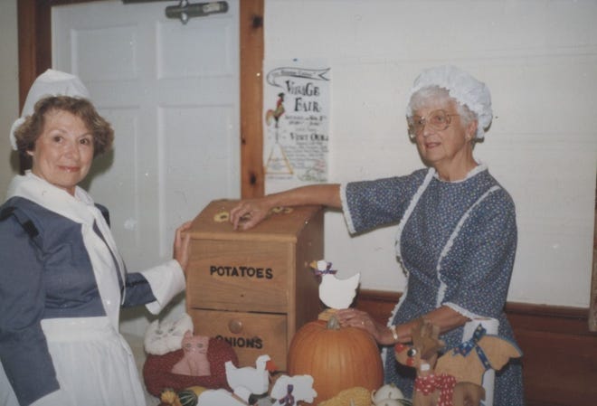 Co-chairs Agnes Rosander and Geraldine Porter display handcrafted articles offered at the Rooster Crows Village Fair held at the West Parish Congregational Church in November 1988. [BARNSTABLE PATRIOT FILES/W.B. NICKERSON CAPE COD HISTORY ARCHIVES]