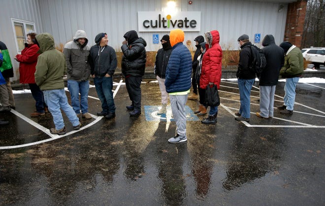 Customers wait outside the Cultivate cannabis dispensary to purchase recreational marijuana on the first day of legal sales, Tuesday, Nov. 20, 2018, in Leicester, Mass. Cultivate is one of the first two shops permitted to sell recreational marijuana in the eastern United States, opening more than two years after Massachusetts voters approved it in 2016. (AP Photo/Steven Senne)