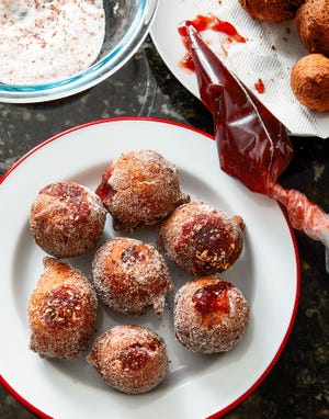 Fried Challah Sufganiyot from "Israeli Soul." The doughnuts are filled with jam and rolled in rose petal sugar. [Michael Persico]