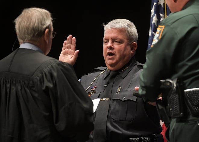 Sarasota County Schools Chief of Police Timothy Enos is sworn in by Judge Lee Haworth at Riverview High School on Tuesday. [Herald-Tribune staff photo / Dan Wagner]