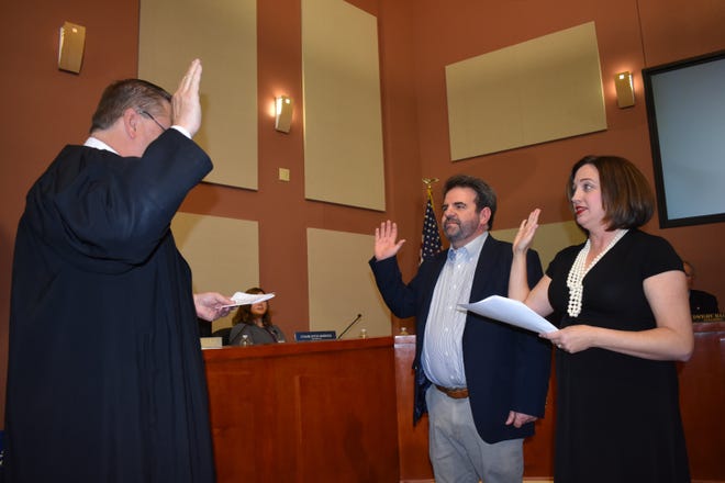 Burnet County Judge James Oakley delivers the oath of office to Lakeway's new city council members Louis Mastrangelo and Laurie Higgenbotham on Nov. 19. Oakley is married to Lakeway Assistant City Manager Julie Oakley. [Photo by Leslee Bassman]