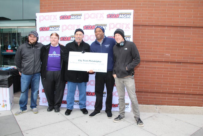 Bryant M. Greene, second from right, owner/administrator of Always Best Care Senior Services of Philadelphia, Bucks and Delaware Counties and the Main Line and Always Best Care Delaware, shares a moment with 102.9 WMGK-FM’s morning host John DeBella, third from left, during the presentation of a $2,500 donation to DeBella’s 18th annual Turkey Drop benefiting City Team Philadelphia. Sharing in the presentation are, from left, Steve Vassalotti, morning show co-host; Joe Clayback, community outreach coordinator for Always Best Care; and Dave Gibson, morning show producer. City Team Philadelphia provides food and services to less fortunate individuals, families, shelters and food groups in the tri-state region. [COURTESY ALWAYS BEST CARE]