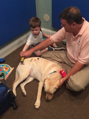 Jon Edenfield of Great Strides Rehabilition Center and Nantuckett, his trained canine companion for independence facility dog, help patients be more receptive to learning. [Provided by Jon Edenfield]