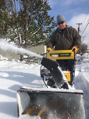 Andy Goodman spends part of Tuesday afternoon plowing the sidewalk in front of Charles WilliamsþÄô house on East South Street. [TOM LOEWY/The Register-Mail]