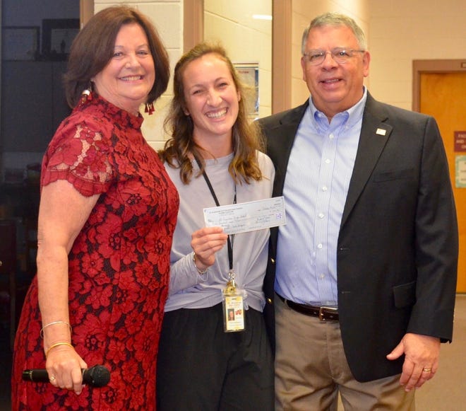Kaila Schlippani, Dance Director of St. Johns County Schools Center for the Arts at St. Augustine High School, accepts a $500 grant from the St. Augustine/Ketterlinus High School Alumni Association. The money will be used purchase an iPad Pro for the dance program. From left: Paula Steele, Schlippani and Doug Wiles. [CONTRIBUTED]