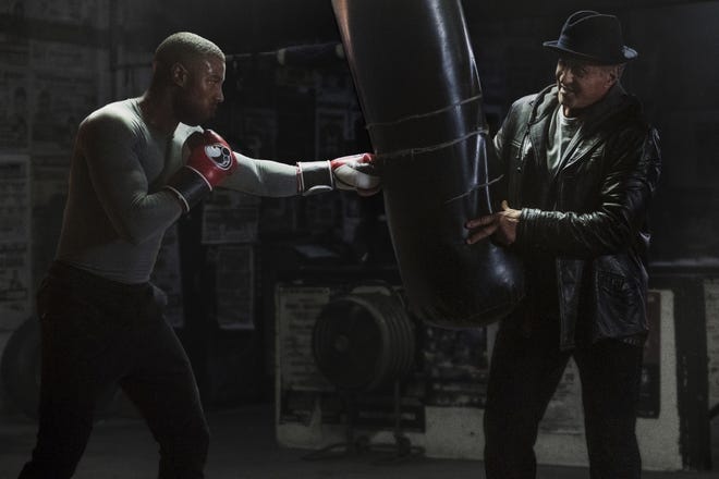 This image released by Metro Goldwyn Mayer Pictures / Warner Bros. Pictures shows Michael B. Jordan, left, and Sylvester Stallone in a scene from "Creed II." (Barry Wetcher/Metro Goldwyn Mayer Pictures/Warner Bros. Pictures via AP)