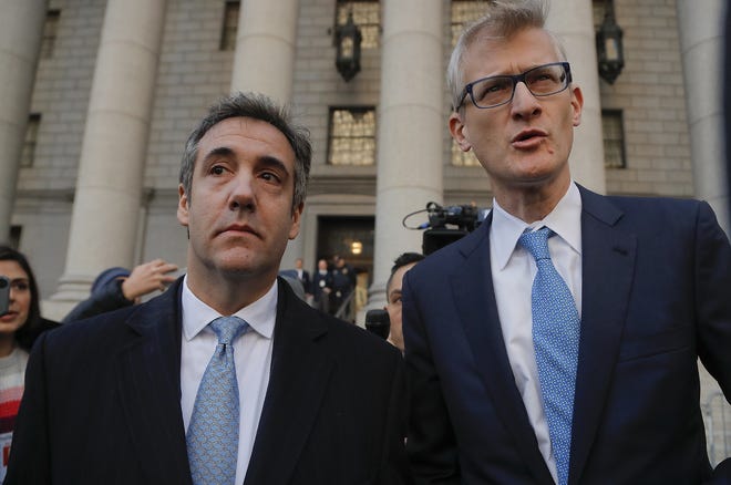 Michael Cohen, left, walks out of federal court with his attorney Guy Petrillo Thursday in New York. Cohen, President Donald Trump's former lawyer, pleaded guilty to lying to Congress about work he did on an aborted project to build a Trump Tower in Russia. He told the judge he lied about the timing of the negotiations and other details to be consistent with Trump's "political message." [JULIE JACOBSON/ASSOCIATED PRESS]