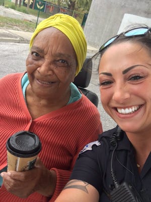 The West Palm Beach Police Department on Wednesday, Feb. 22, 2017, tweeted this photo of Officer Nicole Marie Palladino (left) delivering coffee to an unidentified woman as part of a community relations program. Palladino was arrested Thursday, Nov. 29, 2018, on charges of grand theft, official misconduct and possession of a controlled substance. [Photo provided by the West Palm Beach Police Department on its public Twitter page]