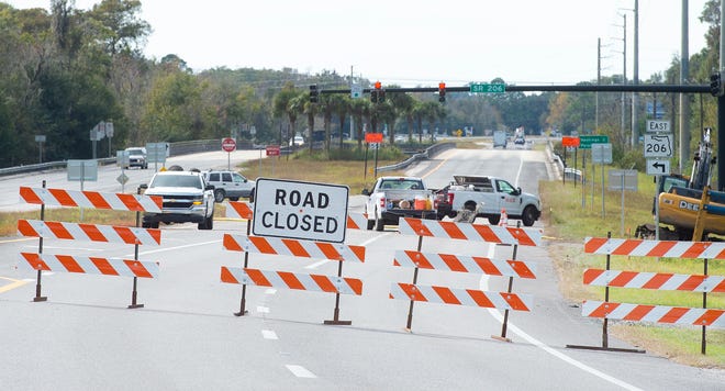 Barriers block the southbound lanes of State Road 207, near State Road 206, on Wednesday to allow work on a drainage improvement project. [PETER WILLOTT/THE RECORD]