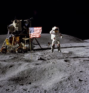 FILE- In this April 1972 photo made available by NASA, John Young salutes the U.S. flag at the Descartes landing site on the moon during the first Apollo 16 extravehicular activity. America's next moon landing will be made by private companies, not NASA. NASA Administrator Jim Bridenstine announced Thursday, Nov. 29, 2018, that nine U.S. companies will compete in delivering experiments to the lunar surface. (Charles M. Duke Jr./NASA via AP, File)