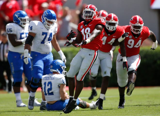 FILE - In this Sept. 15, 2018, file photo, Georgia cornerback Deandre Baker (18) celebrates after making an interception during the first half of the team's NCAA college football game against Middle Tennessee in Athens, Ga. Alabama faces a Georgia secondary led by cornerback Deandre Baker and one of the SEC's top defenses. (Jenn Finch/Athens Banner-Herald via AP, FIle)