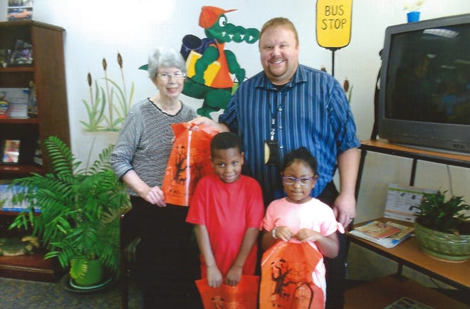 Sadler Elementary students along with Post P member Carol Mabee and guidance counselor Tim hardin show the Halloween bags donated by Gastonia's Post P, TPA. [PHOTOS COURTESY OF LINDA PAYSEUR]