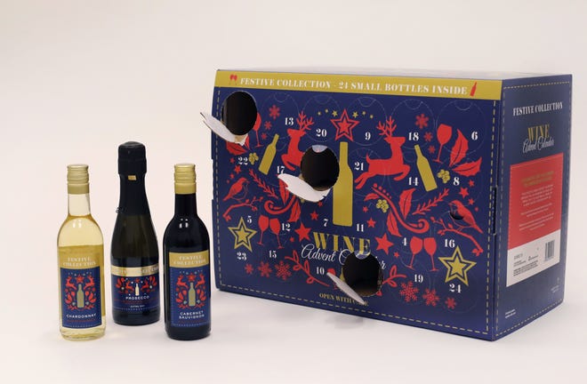In this Nov. 26, 2018, photo Aldi's Wine Advent Calendar is displayed in New York. The cardboard calendars, typically filled with chocolates, are now being stuffed with cans of beer or bottles of wine. And, making a pairing, others are filled with chunks of cheese. The companies behind them say they appeal to nostalgic adults who want to count the days till Christmas with something other than sweets. (AP Photo/Mark Lennihan)