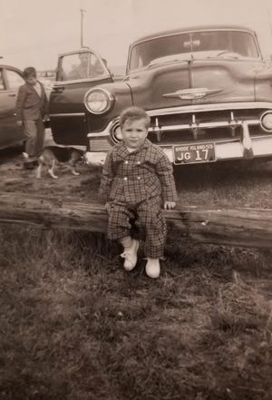 In the foreground, Kevin, a brother, is pictured, with Joey another brother, mom Eileen and Keith, in his mother's arms, as well as Duke, the family dog and a 1959 Chevy. [Courtesy of Keith Giacin]
