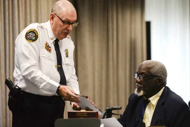 Georgia Association of Chiefs of Police President Joe Wirthman presents a plaque to retired Savannah police Lt. John White at a ceremony in his honor on Friday. White was Savannah police's first black officer. [Will Peebles/Savannahnow.com]