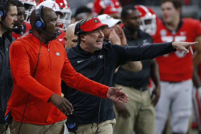Georgia coach Kirby Smart, right, and defensive coordinator Mel Tucker strategize during the Bulldogs' 35-28 loss Saturday in the SEC championship game. (Photo/Athens Banner-Herald)