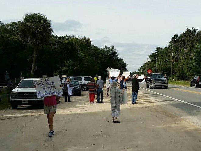 Residents line the shoulder of State Road A1A at Bing's Landing in Flagler County Nov. 25 to protest the county's recent approval of expansion plans for Captain's BBQ restaurant, which is located inside the county-owned park. [Photo provided]