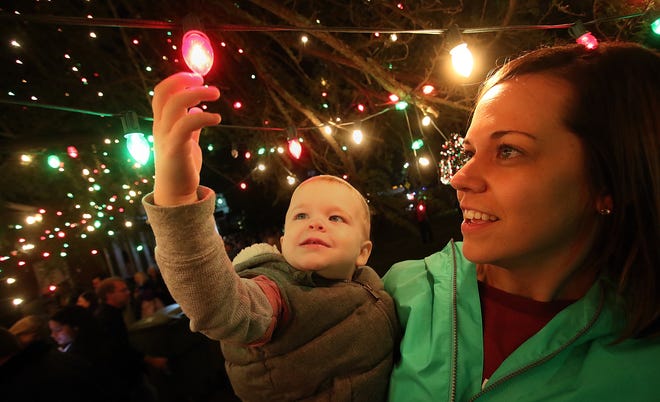 Two-year-old Easton Branch checks out the lights with his mom, Anna Branch, during the 18th Annual Tree Lighting Ceremony in downtown McAdenville Friday evening, November 30, 2018. [Mike Hensdill/The Gaston Gazette]