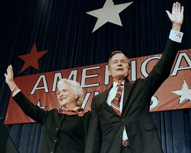 In this Nov. 8, 1988 file photo, President-elect George H.W. Bush and his wife Barbara wave to supporters in Houston, Texas after winning the presidential election. Bush has died at age 94. Family spokesman Jim McGrath says Bush died shortly after 10 p.m. Friday, Nov. 30, 2018, about eight months after the death of his wife, Barbara Bush.
