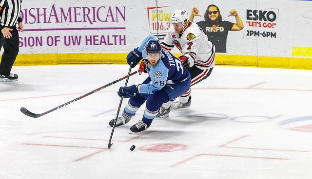 Milwaukee Admirals defender Jarred Tinordi skates with the puck in front of Rockford IceHogs forward Nick Moutrey on Saturday, Dec. 1, 2018 at the BMO Harris Bank Center in Rockford. [PHOTO PROVIDED BY ROCKFORD ICEHOGS]