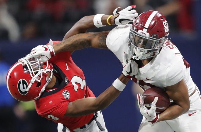 Alabama tight end Irv Smith Jr., right, hits Georgia defensive back Tyson Campbell (3) in the helmet during the first half of the Southeastern Conference championship game, Saturday, in Atlanta. [The Associated Press / John Bazemore]