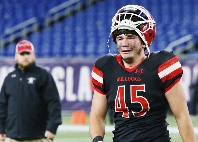 An emotional Dylan DeWolfe leaves the field after Old Rochester's season-ending 26-20 loss to Stoneham in the Div. 6 Super Bowl at Gillette Stadium on Saturday. [MIKE VALERI/THE STANDARD-TIMES/SCMG]