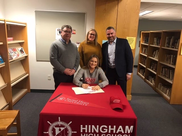 Hingham High senior Elizabeth Jacobson recently signed her National Letter of Intent to play hockey at Sacred Heart University. Pictured, from left: Paul Jacobson, Lisa Jacobson, Elizabeth Jacobson, and Rob Taylor. [COURTESY PHOTO]