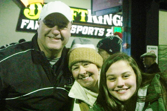 Stoneham football coach Bob Almeida shares a victory smile with his wife Karen, and daughter, Olivia, after his Spartans defeated Old Rochester in a thrilling comeback effort, 26-20 to win the Division 6 Super Bowl championship at Gillette Stadium Dec. 1. [Wicked Local Photo / Joe McConnell]