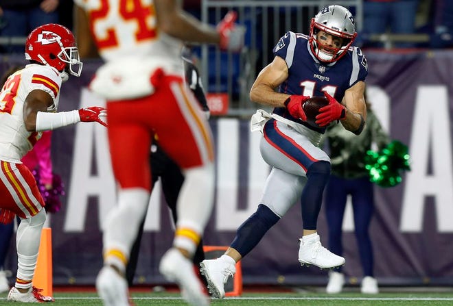 New England Patriots wide receiver Julian Edelman, right, catches a pass for a touchdown during the first half of an NFL football game against the Kansas City Chiefs, in Foxborough, Mass. Edelman has heard anti-Semitic taunts during games, but he had been willing to write them off as opposing fans "just trying to get underneath your skin."