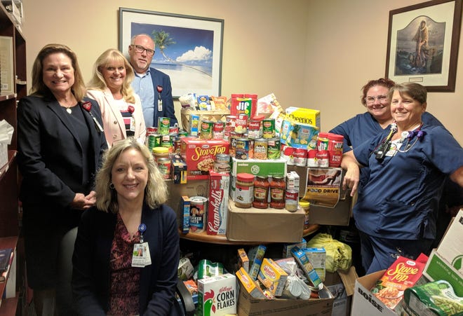Florida Hospital Memorial Medical Center employees collected and donated more than 1,400 pounds of canned goods and non-perishable items to support Food Brings Hope and Halifax Urban Ministries. Pictured here, Florida Hospital Memorial Medical Center executives and representatives from the top three departments with the most donations. [Photo provided]