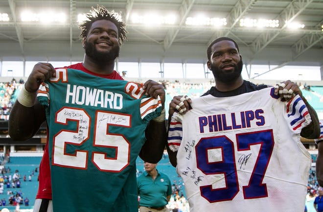 Buffalo Bills defensive tackle Jordan Phillips (left), a former Dolphin, trades jerseys with Dolphins cornerback Xavien Howard after Sunday's game. [ALLEN EYESTONE/palmbeachpost.com]