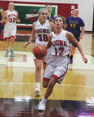 Emily Ades (front) and Emma Dighton (second) are two of the guards who have helped the Boone girls’ basketball team to a 4-0 start this season, while forward Katie Winter (back) averages 8.8 rebounds. Photo by Andrew Logue/News-Republican