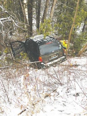 The driver of this vehicle received minor injuries when she lost control on the slushy roads and went down an embankment and struck a tree.