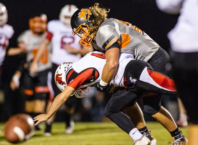 North Davidson's Maddox Johnson (right) interrupts a pass by tackling Central Davidson's Cole Stewart. [Dan Busey/The Dispatch]