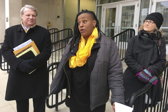 Danielle Atkinson, center, co-chair of MI Time to Care, accompanied by by the group's lawyer, Mark Brewer, and Marta Swain, owner of Grand Rapids-based Clothing Matters, speaks outside the state elections bureau on Monday, Dec. 3, 2018 in Lansing, Mich. Atkinson announced the ballot committee's plan to organize a 2020 paid sick leave initiative if a new law is gutted in the Republican-led Legislature's lame-duck session. (AP Photo/David Eggert)