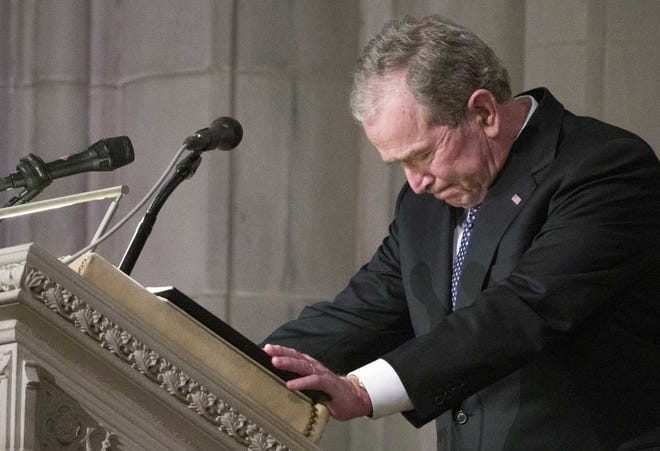 Former President George W. Bush becomes emotional as he speaks at the state funeral for his father, former President George H.W. Bush, at the National Cathedral Wednesday in Washington. [Alex Brandon / Associated Press]