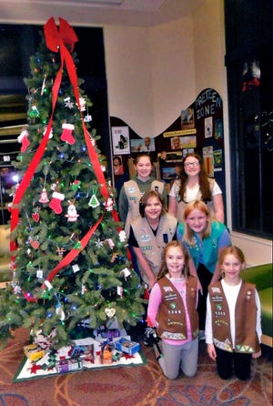 Christmas trees at the Wayne County Public Library in Wooster were decorated with the help of Wooster Area Girl Scouts of Ohio’s Heartland Council. There are more than 20 troops in Wooster and one girl from each level helped with the decorations. The troops have been doing this service project and tradition for more than 30 years. Helping with the project were, front, left: Daisy Witter, Brownie Troop 1328 and Maria Kuzma, Brownie Troop 4203; middle, left: Isabelle Castellucci, Cadette Troop 2215 and Kaydence Stoll, Junior Troop 2334; back, left: Twyla Woodall, Senior Troop 2334 and Maggie Snyder, Ambassador Troop 1839.