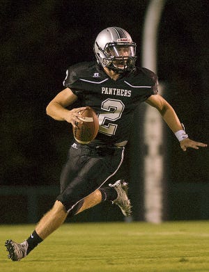 Ledford quarterback Walker Lackey looks to pass during a game earlier this season. [Donnie Roberts/The Dispatch]