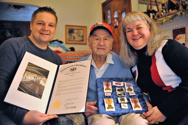 State Rep. Aaron Bernstine, R-10, New Beaver, left, honored former Ellport Mayor Nicholas C. Risko, center, with a citation Wednesday afternoon for Risko's 95th birthday. Risko's daughter Tracey Risko, right, helps her father hold his medals. [Dani Fitzgerald/ECL Staff]