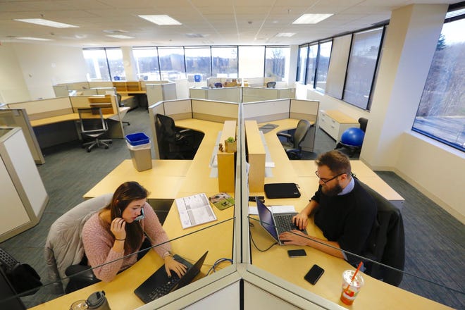 Reporters Mary Whitfill and Joe DiFazio were among the first to be up and running at The Patriot Ledger's new newsroom at 2 Adams Place, Quincy. (Greg Derr/The Patriot Ledger)