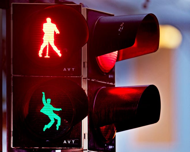 Walking figures depicting late US rock and roll legend Elvis Presley appear on a traffic light switching from green to red in Friedberg near Frankfurt, Germany, Thursday, Dec. 6, 2018. Presley served in Friedberg from October 1958 to March 1960 as a soldier in the US Armed Forces.( AP Photo/Michael Probst)
