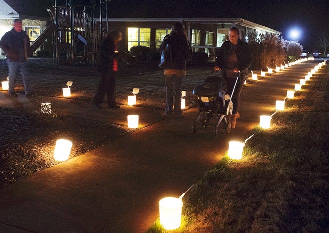 Visitors to Hospice of Davidson County on Thursday night walk among the 450 luminaries with namecards during Hospice's annual 'Night of Reflection' held for community members to remember and honor loved ones the their memories. [Donnie Roberts/The Dispatch]