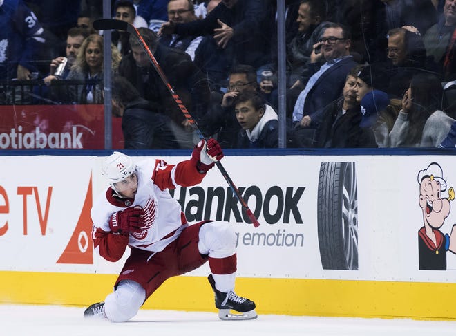 Detroit Red Wings center Dylan Larkin (71) reacts after scoring in overtime NHL against the Toronto Maple Leafs in Toronto on Thursday, Dec. 6, 2018. (Nathan Denette/The Canadian Press via AP)