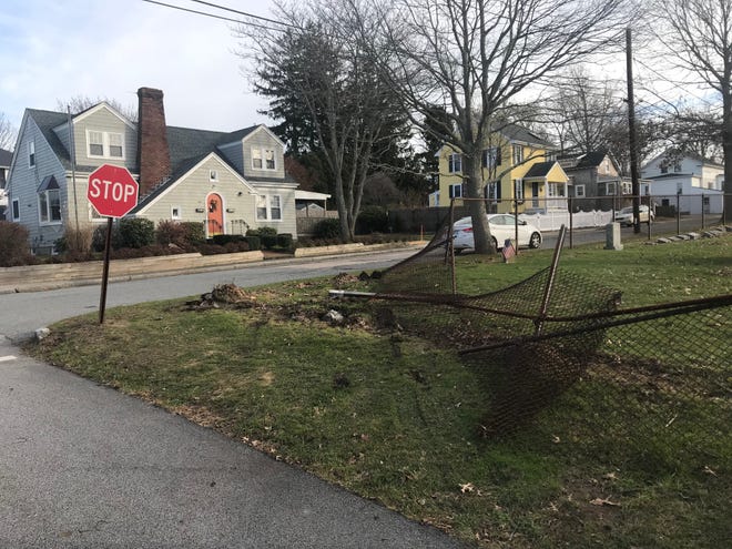 A fence was damaged at the corner of Evarts and Butler streets in Newport during a police chase on Wednesday. What happened? [RACHAEL THATCHER/ DAILY NEWS PHOTO]