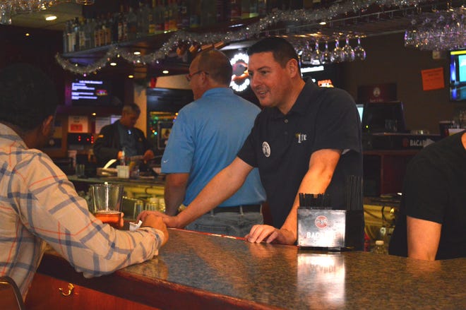 Loves Park Mayor Greg Jury, left, and state Rep. John Cabello, R-Machesney Park, serve as guest bartenders Thursday, Dec. 6, 2018, at Rascals Bar & Grill in Loves Park. The goal of the event was to raise $25,000 to purchase a new K-9 police dog for the city. [SUSAN VELA/RRSTAR.COM STAFF