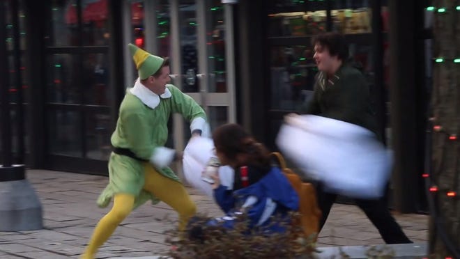 Brendan Edwards dressed as Buddy the Elf to challenge strangers to pillow fights on the streets of Boston.