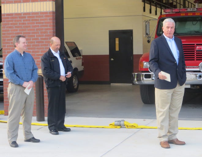 Oconee County Commission Chairman John Daniell, left, and Fire Chief Bruce Thaxton listen as construction firm owner Kevin Price speaks at a ribbon cutting on Thursday. [Wayne Ford/Athens Banner-Herald]